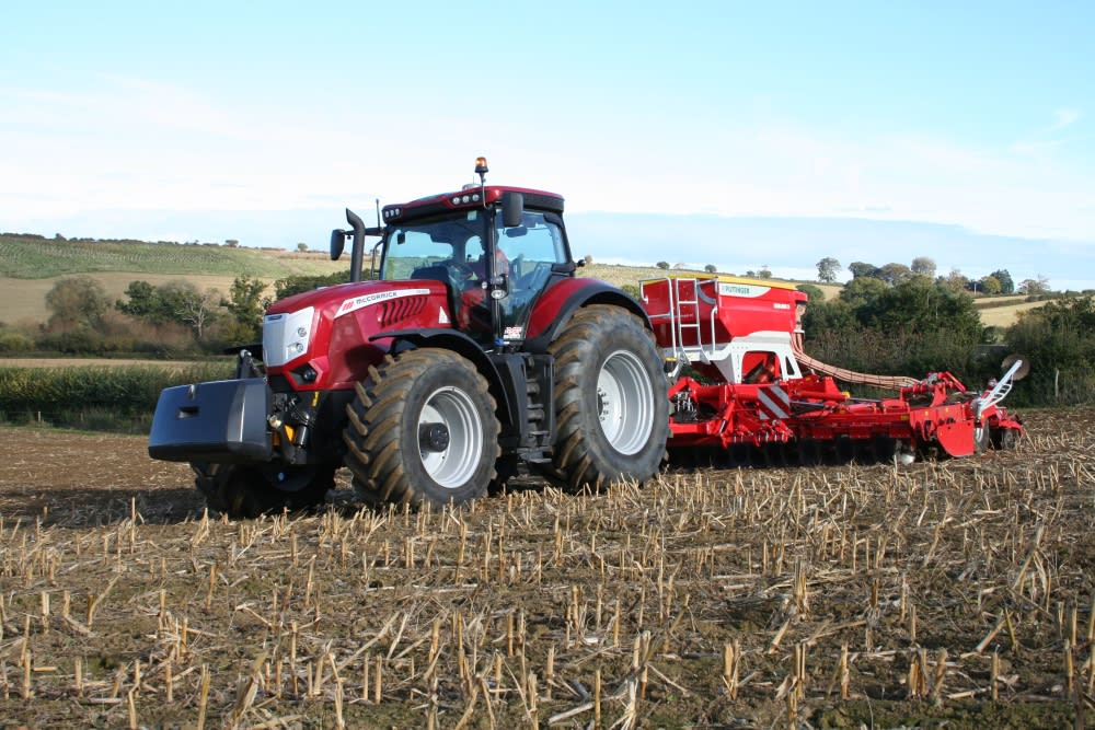 This images shows the McCormick X8 VT-Drive at work with a Pottinger seed drill