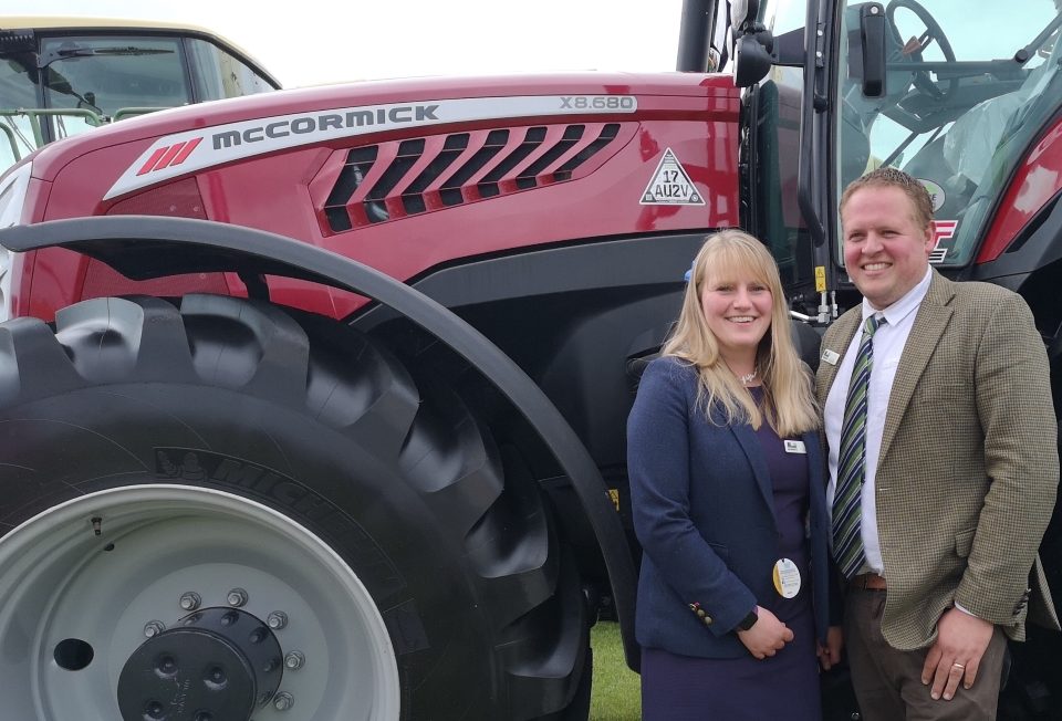 Show Liz and David Moore with a McCormick tractor